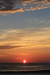 Scenic view of sea against romantic sky at sunset