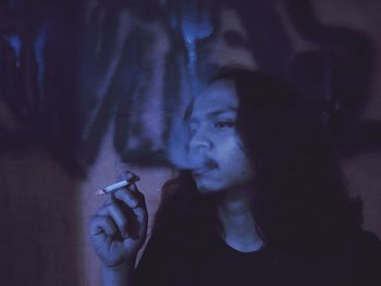 Portrait of man smoking cigarette