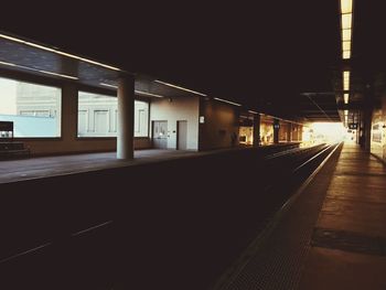 Empty illuminated railroad station at night