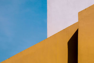 Low angle view of building against clear blue sky