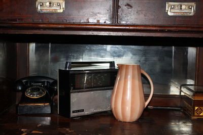 View of vintage radio and telephone on table