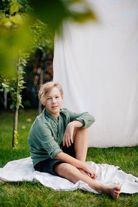 Young woman sitting on field