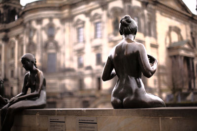 Close-up of naked woman statues in city