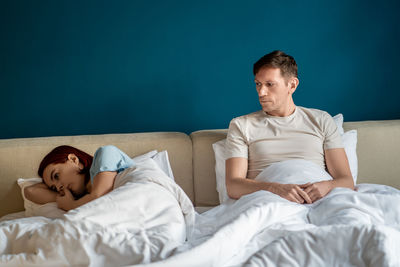 Young woman sleeping on bed at home