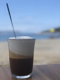 Close-up of coffee on table against sea