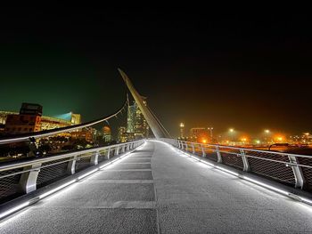 Illuminated bridge at night