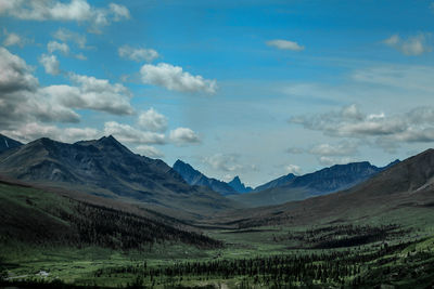 Scenic view of mountains against cloudy sky