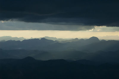 Scenic view of silhouette mountains against sky during sunset