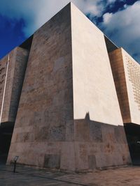 Low angle view of building against cloudy sky