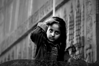 Portrait of boy looking at camera against wall