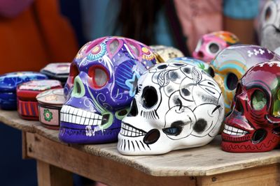 Close-up of colorful skulls on table