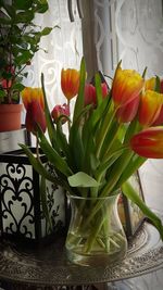 Close-up of tulips in vase on table at home