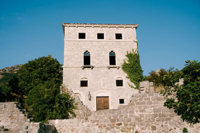 Low angle view of building against clear blue sky