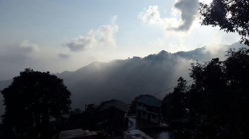 Scenic view of mountains against cloudy sky