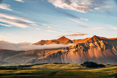 Scenic view of landscape against dramatic sky