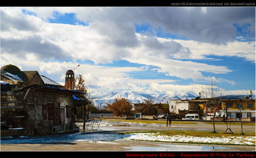 Buildings against cloudy sky