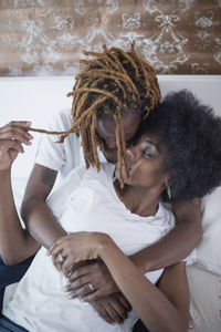 Lesbian couple embracing on bed