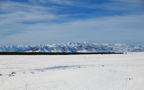 Scenic view of snowcapped mountains against sky
