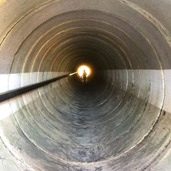 Man in illuminated tunnel