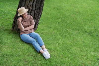 High angle view of man sitting on grassland