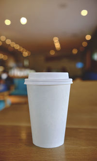 Close-up of disposable cup on table
