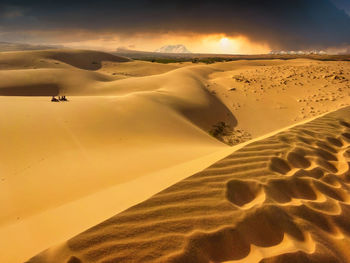 Scenic view of desert against sky during sunset