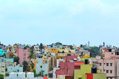 Buildings in city against clear sky