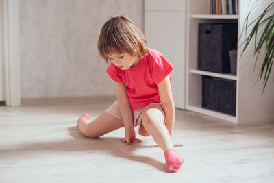 Side view of young woman exercising in gym