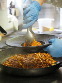 Cropped hand preparing food in kitchen