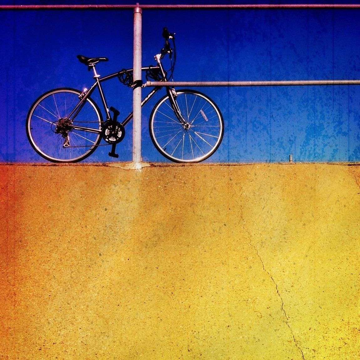 bicycle, transportation, mode of transport, land vehicle, blue, stationary, clear sky, wall - building feature, wheel, day, built structure, shadow, sunlight, low angle view, street, architecture, outdoors, parked, parking, copy space