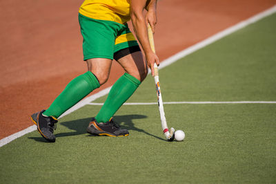 Low section of man playing hockey