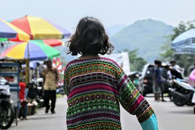 Rear view of girl standing on street