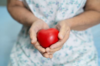 Close-up of woman holding red hand