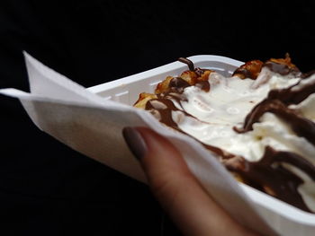 Close-up of hand holding ice cream