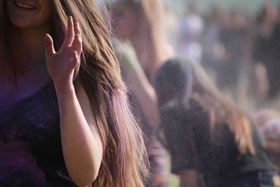 Cropped image of woman enjoying color festival