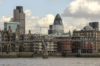 View of cityscape against cloudy sky