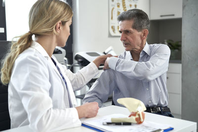 Doctor examining patient in clinic