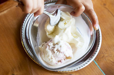 Midsection of person holding ice cream in bowl