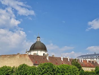 Temple by building against sky