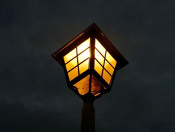 Low angle view of illuminated street light against sky