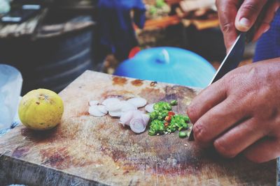 Close-up of person preparing food on cutting board