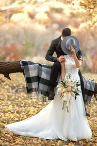 Rear view of woman holding bouquet