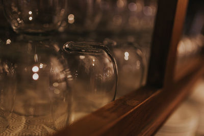 Close-up of glasses arranged in shelf