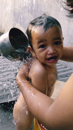 Portrait of shirtless boy in water