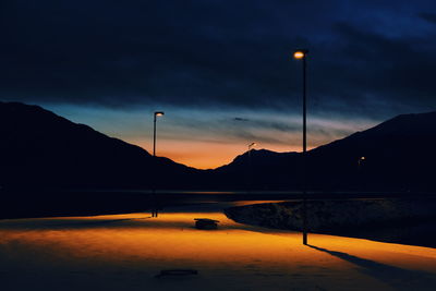 Scenic view of lake against sky at sunset