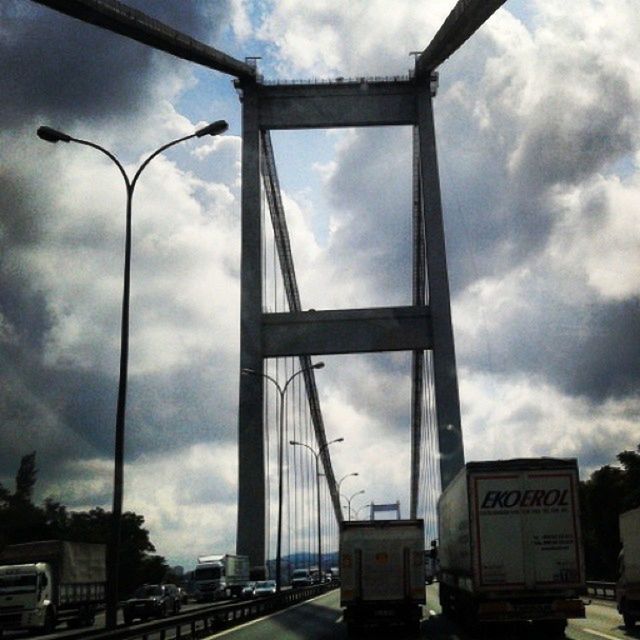 LOW ANGLE VIEW OF ROAD AGAINST CLOUDY SKY