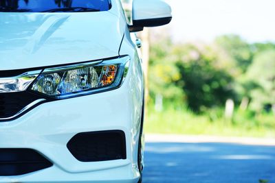 Close-up of car on road