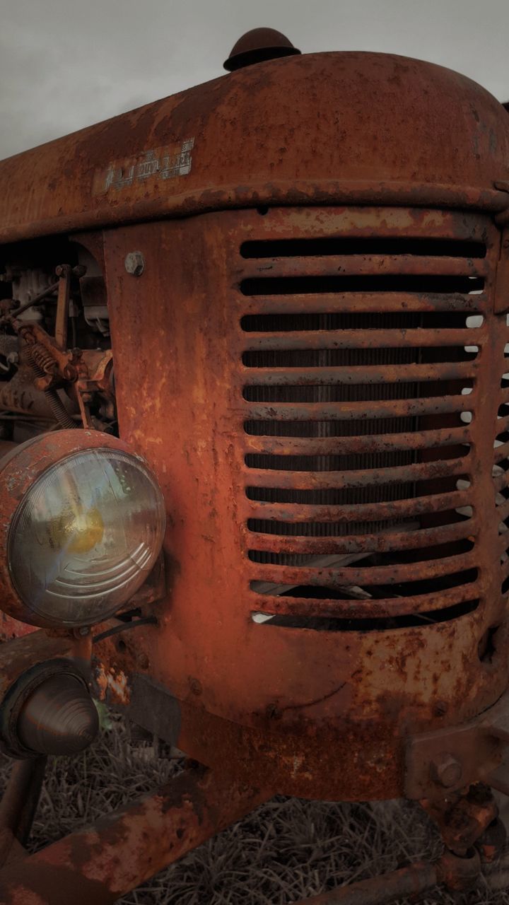 CLOSE-UP VIEW OF RUSTY ABANDONED MACHINE PART