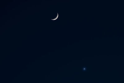 Low angle view of moon against sky at night