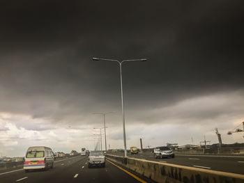 Cars on highway against sky